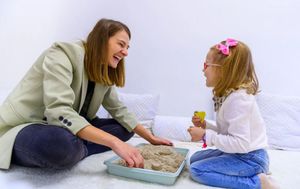Woman in White Long Sleeve Shirt Holding Pink and White Floral Textile